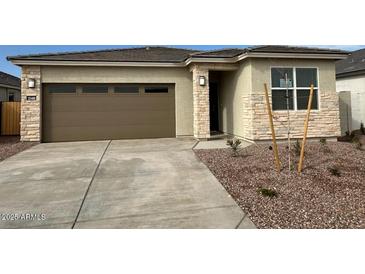 New single-story home with two-car garage and neutral color scheme at 25488 N 183Rd Ln, Wittmann, AZ 85361