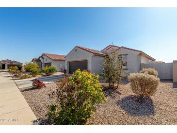 Single-story home with two-car garage and desert landscaping at 1673 E Jardin Pl, Casa Grande, AZ 85122
