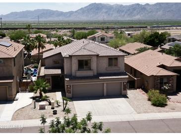Two-story home featuring desert landscaping, a spacious driveway, and a two-car garage in a community setting with mountain views at 1801 W Nighthawk Way, Phoenix, AZ 85045