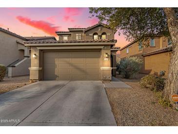 Two-story house with a two-car garage and desert landscaping at 18320 N Betty Ct, Maricopa, AZ 85138