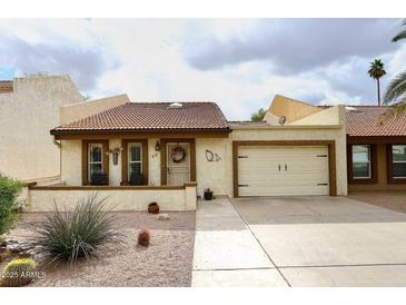 Cute stucco home with tile roof, two-car garage, and landscaped front yard at 2329 N Recker Rd # 23, Mesa, AZ 85215