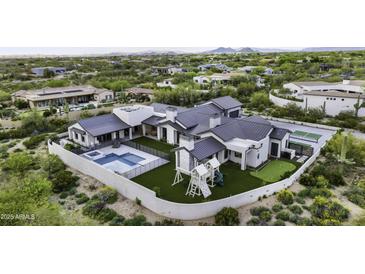 Aerial view showcases a luxurious home with a pool, playground, and large backyard at 25582 N 89Th St, Scottsdale, AZ 85255