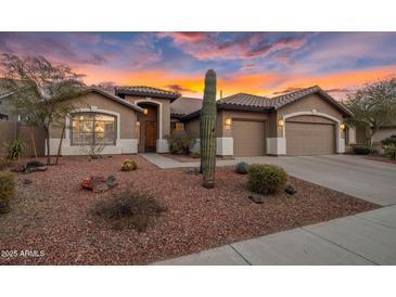 Beautiful desert landscaping surrounds this single-story home with a two-car garage at 26803 N 45Th Pl, Cave Creek, AZ 85331