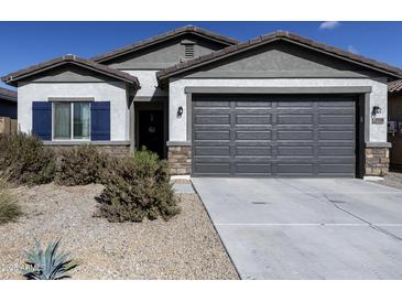 Single-story house with a two-car garage and desert landscaping at 35208 W Santa Monica Ave, Maricopa, AZ 85138