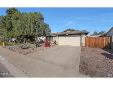 House exterior featuring a driveway, garage, and well-maintained landscaping at 7132 W Vermont Ave, Glendale, AZ 85303