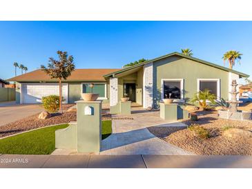 Single-story house with a green exterior, landscaping, and a paved walkway at 902 W Curry St, Chandler, AZ 85225