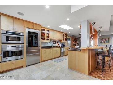 Modern kitchen with stainless steel appliances and light wood cabinetry at 2631 E Beekman Pl, Phoenix, AZ 85016