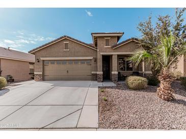 Single-story home with two-car garage and desert landscaping at 514 S 224Th Dr, Buckeye, AZ 85326