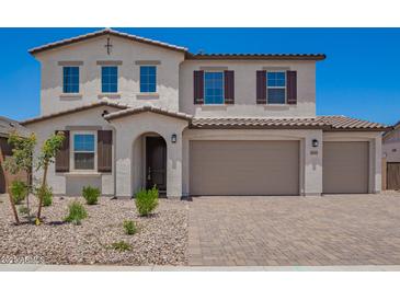 Charming two-story home boasts a three-car garage, desert landscaping, and a stylish mix of stucco and tile accents at 12362 W Marguerite Ave, Avondale, AZ 85323