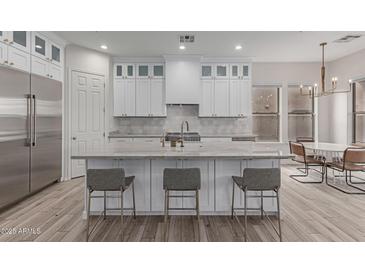 Spacious kitchen with white cabinets, large island, and stainless steel appliances at 18196 N 92Nd St, Scottsdale, AZ 85255