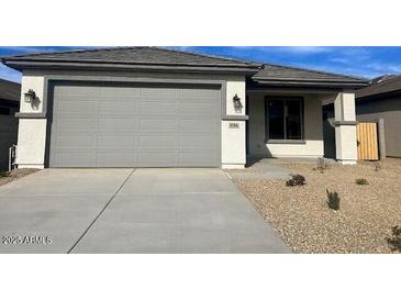 New single-story home with gray exterior and two-car garage at 18366 W Poston Dr, Surprise, AZ 85387