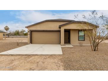 Newly built single-story home with a two-car garage and neutral color scheme at 3705 N Algodon Dr, Eloy, AZ 85131