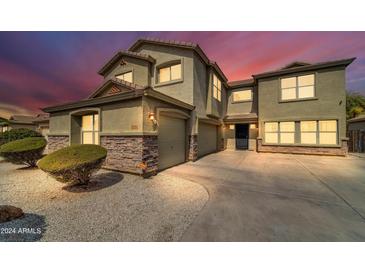 Two-story house with a large driveway and landscaping at 4628 W Hasan Dr, Laveen, AZ 85339