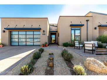 Modern home with landscaped front yard, two-car garage, and inviting entryway at 12451 E Troon Vista Dr, Scottsdale, AZ 85255