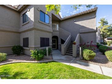 Attractive condo building exterior with landscaping and stairs at 15225 N 100Th St # 1208, Scottsdale, AZ 85260