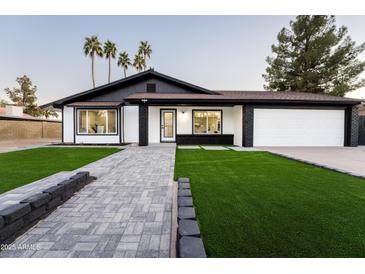 Stunning curb appeal featuring a remodeled home with a paved walkway and lush landscaping at 1743 W Butler Dr, Phoenix, AZ 85021
