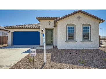 Charming single-story home with a blue garage door, neutral stucco, and tile roof at 17603 W Superior Ave, Goodyear, AZ 85338