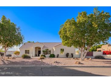 Single-story home with landscaped yard and two-car garage at 23204 N Paseo Laredo Ln, Peoria, AZ 85383