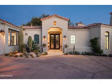 Spanish style home with double doors and desert landscaping at 9290 E Thompson Peak Pkwy # 422, Scottsdale, AZ 85255