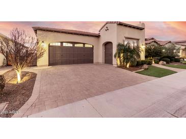 Single-story home with a two-car garage and attractive landscaping at 1175 E Copper Holw, Queen Creek, AZ 85140