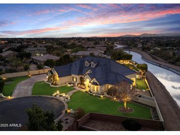 Luxury home with circular driveway, beautifully landscaped yard, and canal views at 1233 E Salado Cir, Mesa, AZ 85203