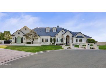 Elegant two-story home with a landscaped lawn and a grand facade at 1233 E Salado Cir, Mesa, AZ 85203