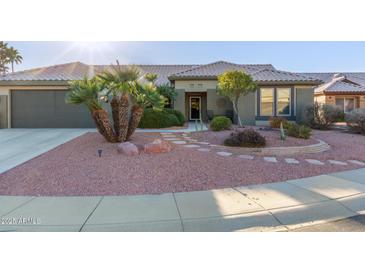 Single-story home with a tile roof, landscaping, and a two-car garage at 21806 N Aztec Ct, Sun City West, AZ 85375