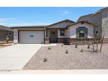 Charming single-story home featuring a neutral color palette, a two-car garage and low-maintenance landscaping at 23048 E Watford Dr, Queen Creek, AZ 85142