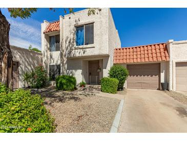 Charming two-story stucco home with tile roof and landscaped front yard at 2548 W Monte Cristo Ave, Phoenix, AZ 85023