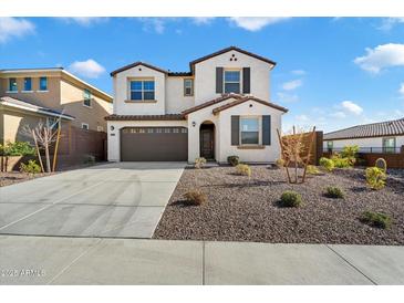 Two-story house with attached garage and landscaped front yard at 31957 N 125Th Ave, Peoria, AZ 85383