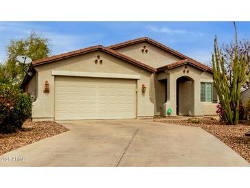 Charming single-story home featuring a two-car garage, desert landscaping, and a neutral stucco exterior at 42374 W Avella Dr, Maricopa, AZ 85138