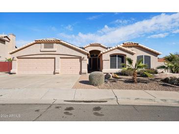 Beautiful stucco home with two-car garage and desert landscaping at 7869 W Kristal Way, Glendale, AZ 85308