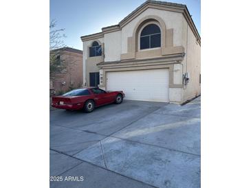 Two-story house with attached garage and driveway at 1340 S 232Nd Ave, Buckeye, AZ 85326