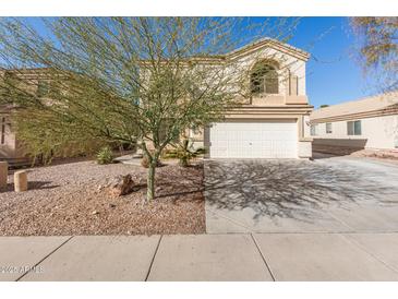 Two-story house with a white garage door and landscaping at 1340 S 232Nd Ave, Buckeye, AZ 85326