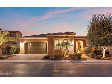 Beautiful desert home with landscaped yard, driveway, and three-car garage at 1457 E Copper Holw, Queen Creek, AZ 85140