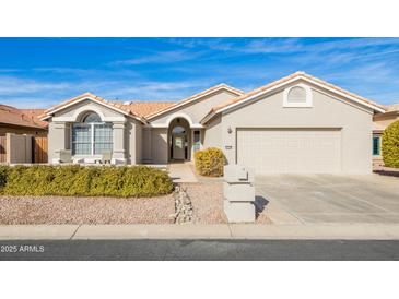 Single-story home with a two-car garage and well-manicured landscaping at 15430 W Amelia Dr, Goodyear, AZ 85395