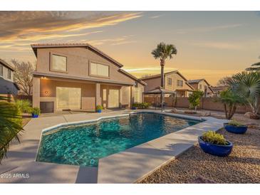 Inviting backyard pool with a gazebo and surrounding landscaping at 1723 E Cotton Ct, Gilbert, AZ 85234