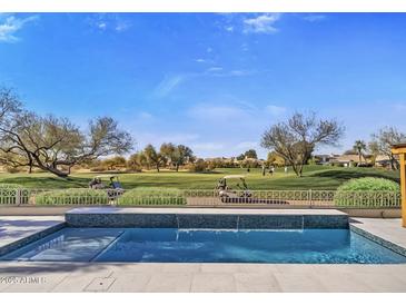 Luxury pool with golf course view; outdoor kitchen and seating area at 17444 N 79Th St, Scottsdale, AZ 85255