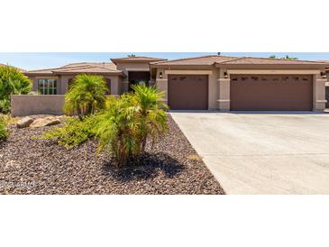 Two-story house with a three-car garage and landscaped front yard at 17925 W Mauna Loa Ln, Surprise, AZ 85388