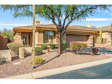 Single-story home with desert landscaping, two-car garage, and neutral exterior at 41604 N Cedar Chase Rd, Anthem, AZ 85086