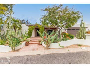 Stunning curb appeal with desert landscaping and a charming entrance at 4622 E Palo Verde Dr, Phoenix, AZ 85018