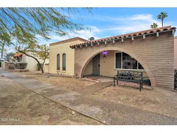 Front view of a charming single story home with arched entryway at 526 N Hobson Plz, Mesa, AZ 85203