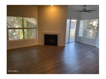 Bright living room with fireplace and sliding glass door to patio at 600 W Grove Pkwy # 2067, Tempe, AZ 85283