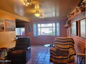 Bright living room with tiled floors, comfortable seating, and southwestern decor at 8221 E Garfield St # L122, Scottsdale, AZ 85257