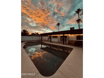 Inviting pool and patio area with stunning sunset views at 941 W Peralta Ave, Mesa, AZ 85210