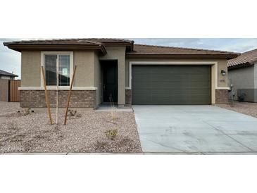 New single-story home with a two-car garage and desert landscaping at 15798 W Hackamore Dr, Surprise, AZ 85387