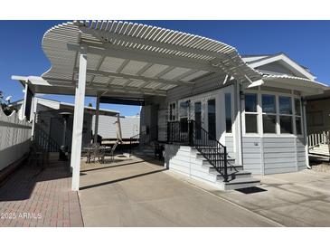 Home exterior featuring a covered patio and landscaping at 17200 W Bell Rd # 196, Surprise, AZ 85374