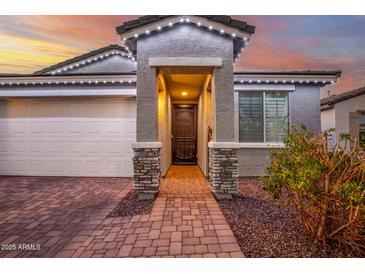 Attractive home exterior with a charming entryway and landscaping at 17440 W Eugene Ter, Surprise, AZ 85388