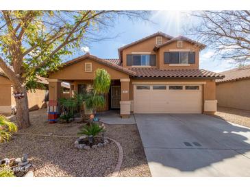 Two-story house with a tan exterior, two-car garage, and landscaping at 835 E Marigold Pl, San Tan Valley, AZ 85143