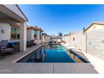 Relaxing pool area with patio furniture and a covered patio at 18254 W Via Montoya Dr, Surprise, AZ 85387